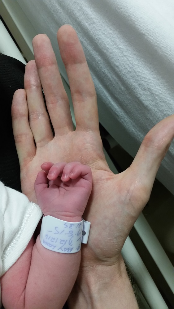 Baby James holding finger